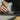 Person using a stylus on a digital drawing tablet with a blurred background