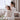Woman and child in white robes sitting on a couch with a hair dryer